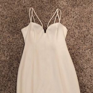 White dress with gold trim at top